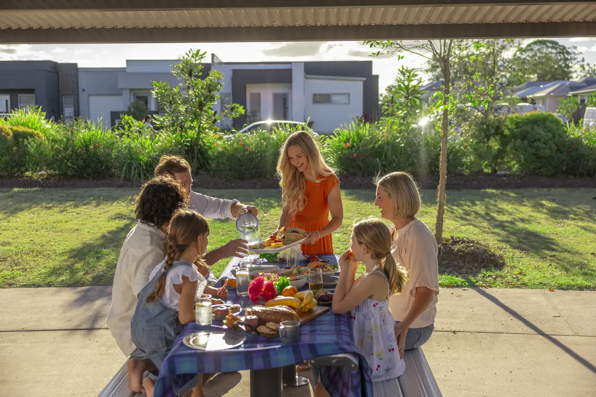 A family sharing lunch at an outdoor table